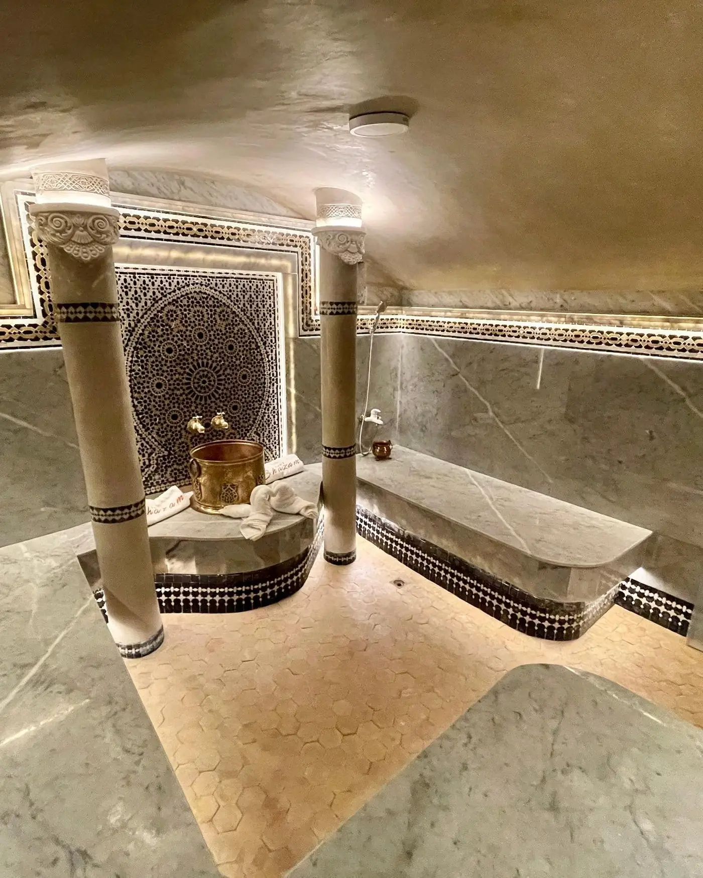 The marble hammam at Palais Shazam with zellige mosaic and carved columns